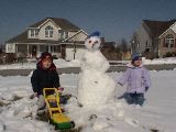 Look at our snowman!  And what am I doing with a lawnmower in February?